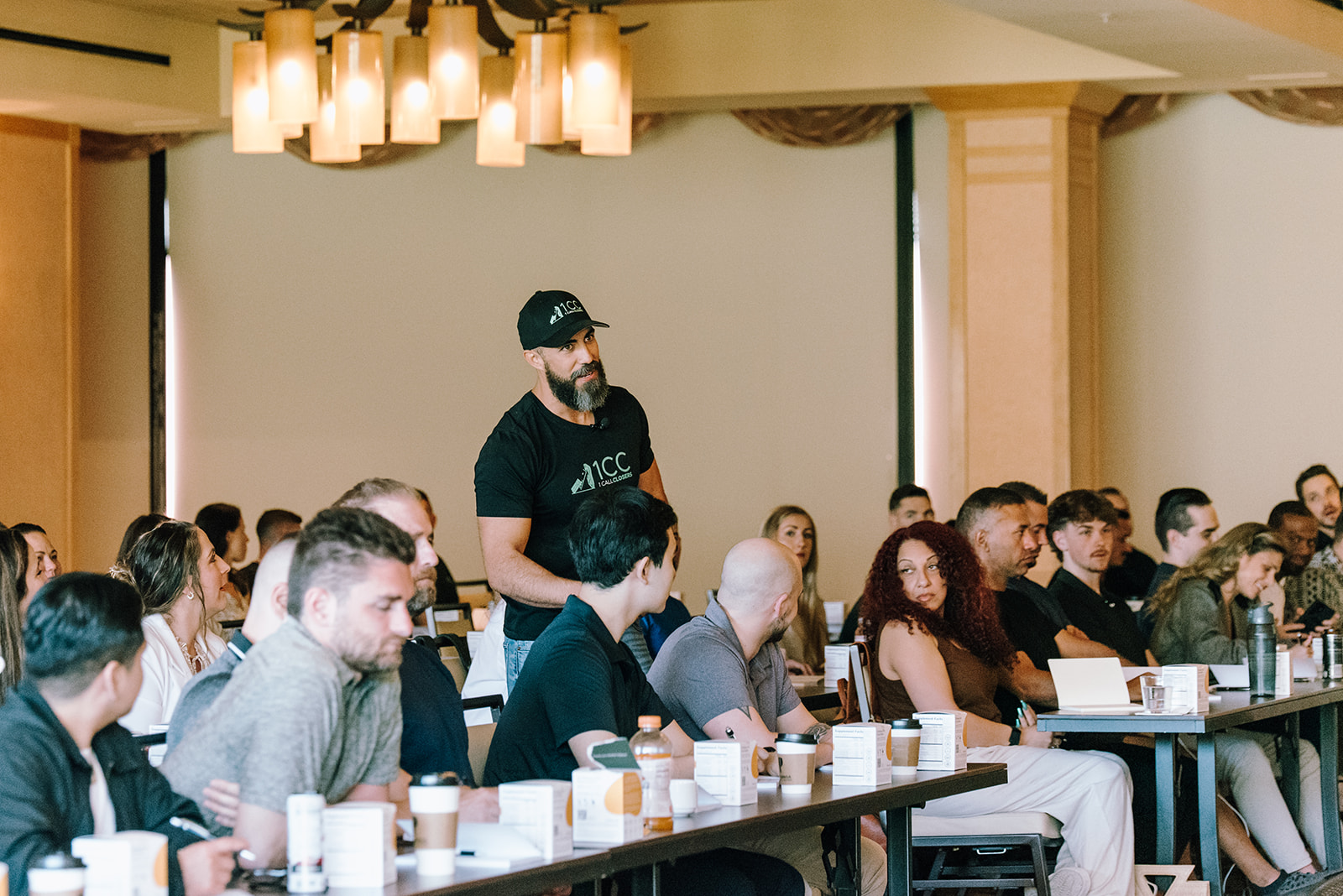 Richard Mugica engaging with attendees during a 1CC training session.