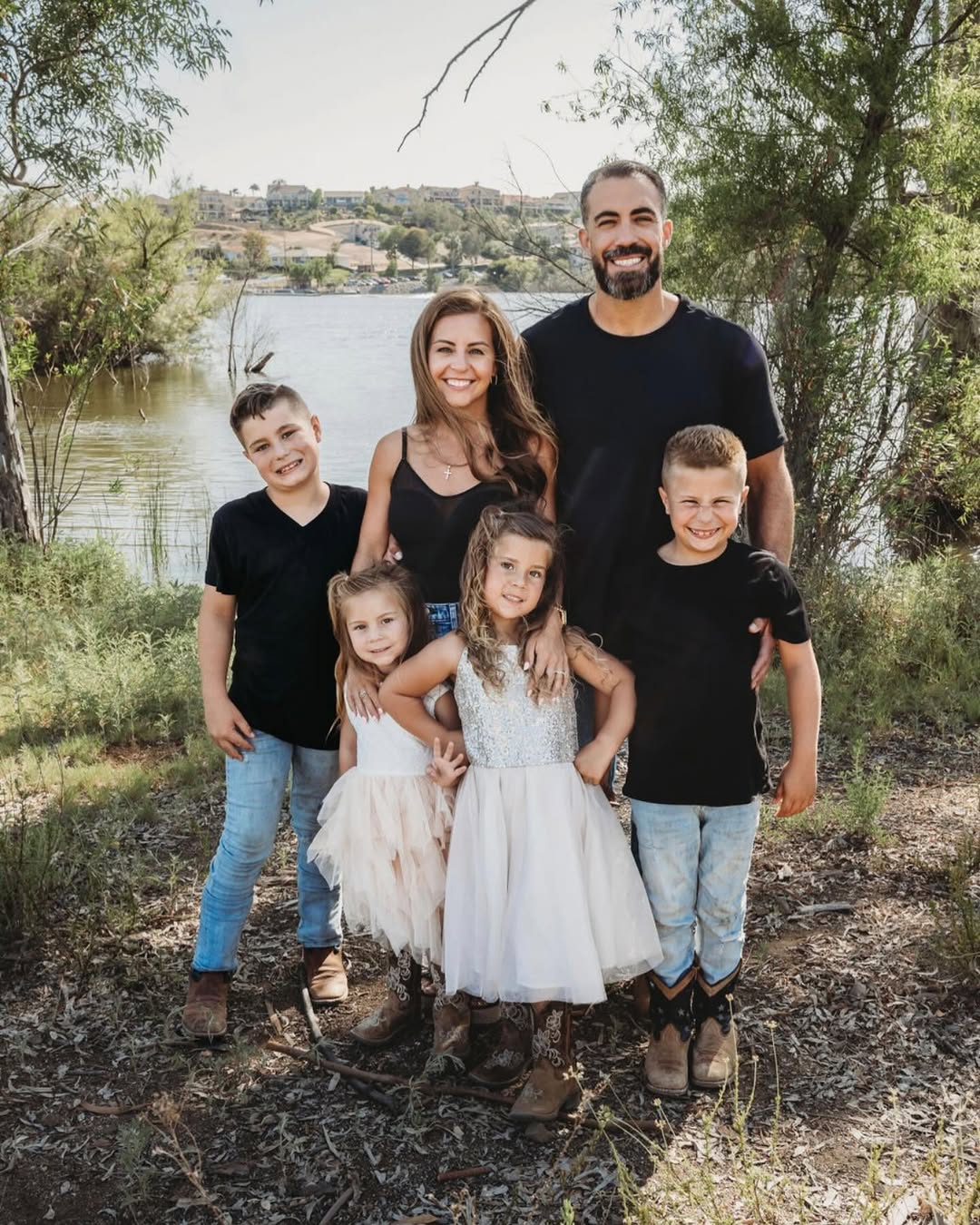 Richard and Hailey Mugica with their four children by a lake.