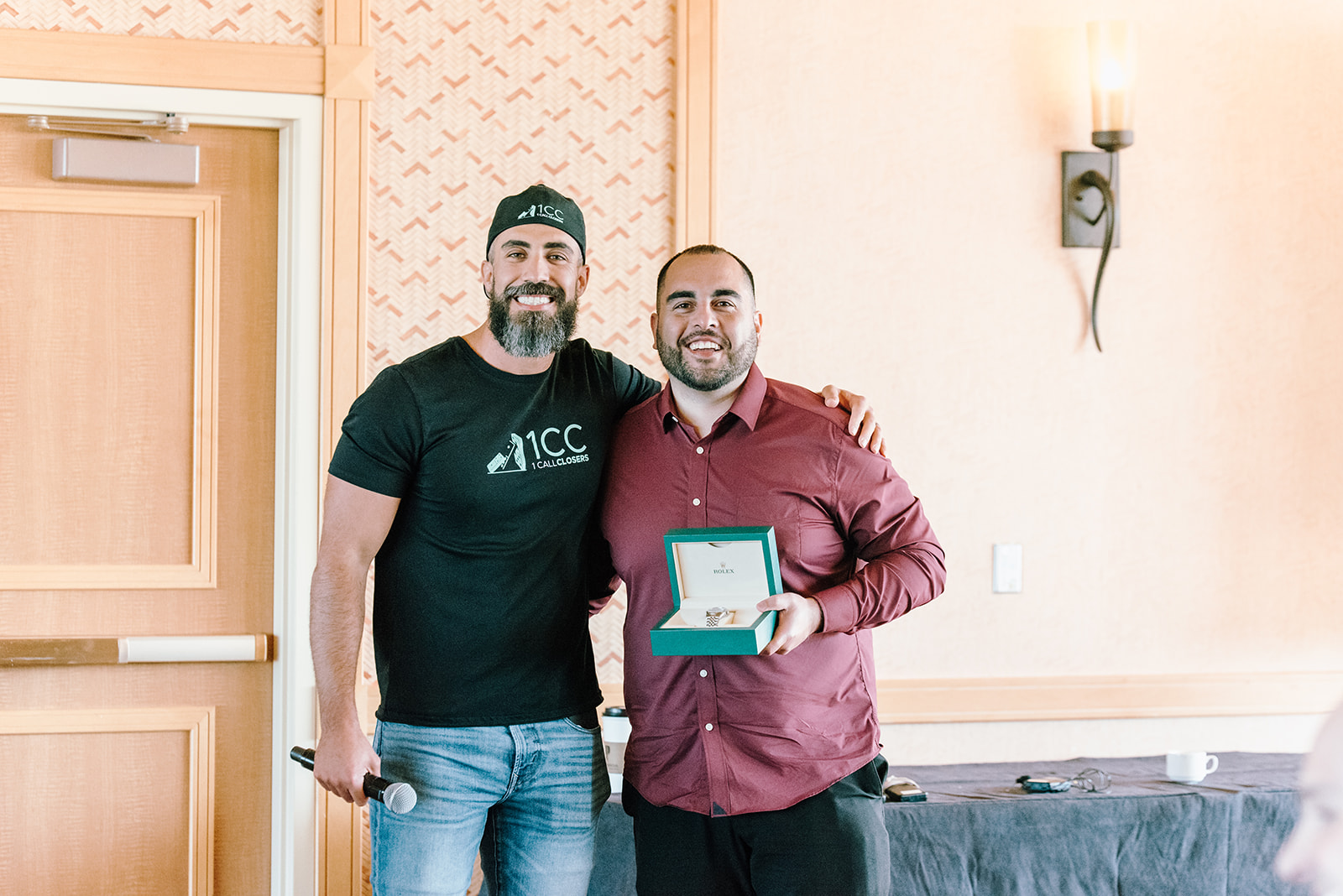 Richard Mugica presenting a Rolex watch to a top-performing client.